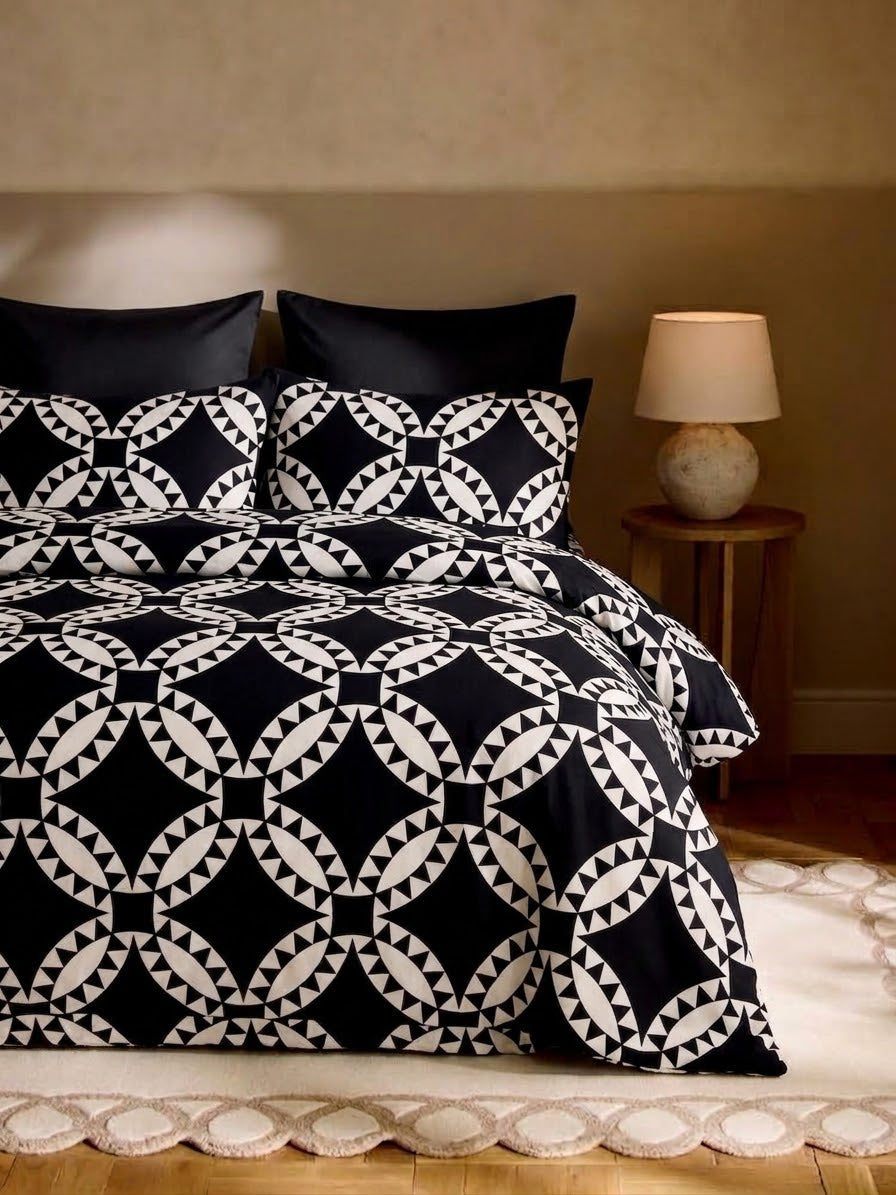 Marrakech Noir black and white ring medallion print bedsheet set on a bed