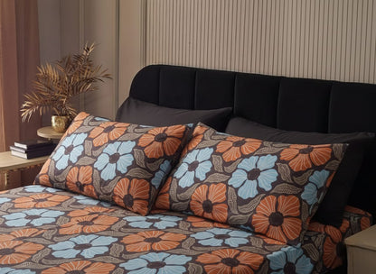 Floral patterned bedding set on a bed with a striped wall in the background